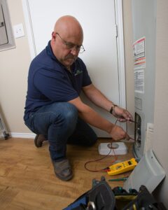 man fixing A/C unit