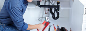 man repairing pipe