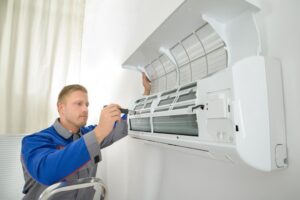 man fixing ac unit