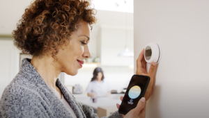 woman checking temperature on thermometer
