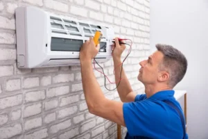 man inspecting ac unit
