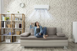 woman sitting below ac unit