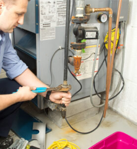 man repairing hvac system pipe