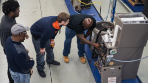 men being trained on hvac machine