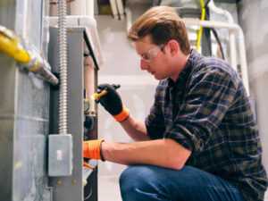 man doing repair on furnace