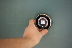 person turning dial on thermometer
