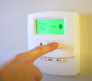 person changing temp on thermometer