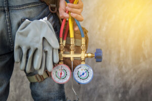 person holding AC measuring tools